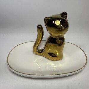 Ceramic Gold Cat ring holder on White catch all dish.